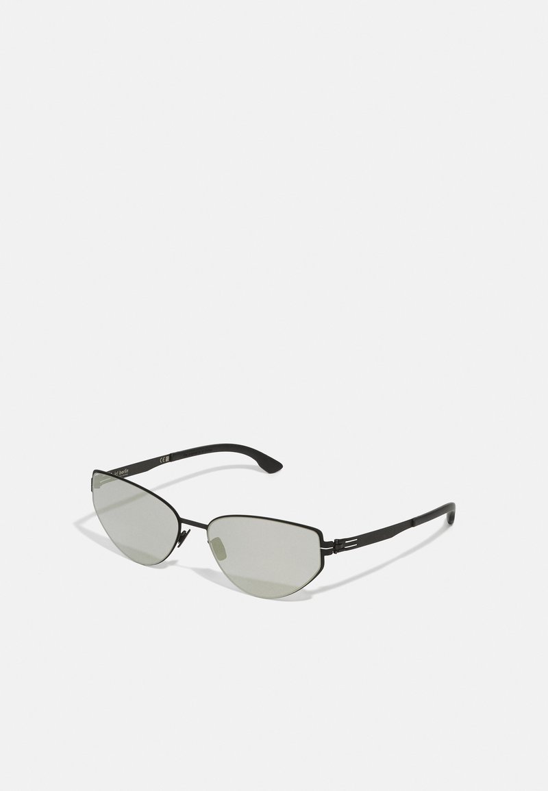 Black metal cat-eye sunglasses with gray tinted lenses, featuring angular frames and slim arms. Minimalist design with no embellishments.