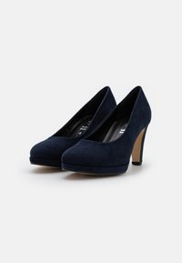 Navy blue suede high-heeled shoes with a rounded toe, platform front, and a beige heel. Smooth texture with no visible patterns or accents.