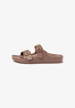 Brown slip-on sandal with two adjustable buckle straps and contoured sole, shown in side profile on white background.