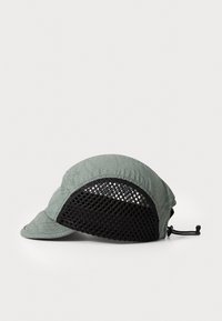 Green patterned cap with a soft fabric front and breathable black mesh sides. Features an adjustable drawstring at the back.