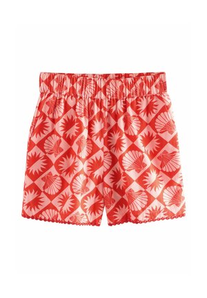 Red cotton shorts with elastic waistband, featuring a repeating shell and starburst pattern, scalloped hem, and lightweight texture.