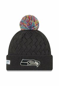Knit black beanie with multicolored pom-pom on top. Features a woven pattern and a logo patch depicting a bird's head on the cuff.