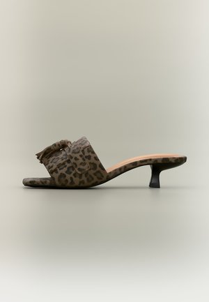 Mule marron imprimé léopard avec détail pompon et petit talon kitten noir, vue de côté sur fond neutre.