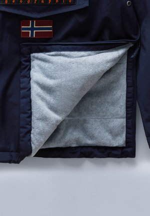 Jachetă albastră marină cu un căptușeală texturată din fleece gri și un patch cu steagul norvegian. Buzunar cu fermoar vizibil în interior.