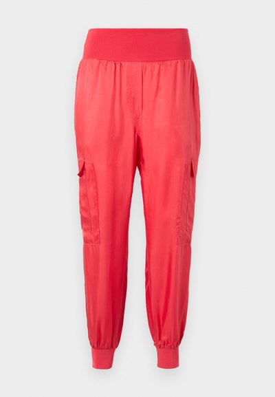 Red satin jogger pants with a wide elastic waist, side pockets, and elastic cuffs at the ankles. Smooth finish with a slight shine.
