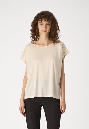 Light beige short-sleeve top with a relaxed fit. Features lace detailing on shoulders. Made from soft, lightweight fabric.