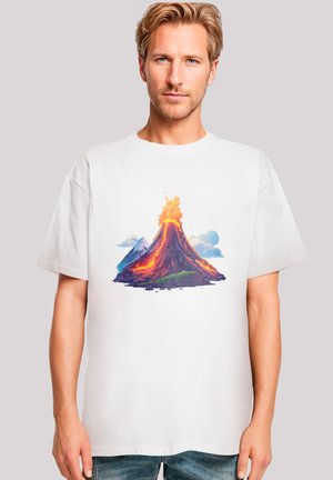 White cotton t-shirt featuring a colorful volcano graphic with lava, mountains, and clouds, showcasing vibrant reds, oranges, and blues.