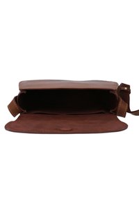 Brun läder crossbody-väska med klaff öppen, som visar det tomma innanmätet och sydda kanter.