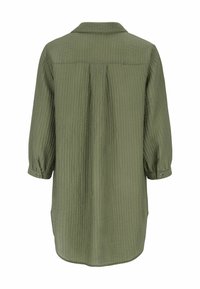 Groene, gekraagde jurk van textuurstof met lange mouwen en knoopmanchetten. Beschikt over een achterkant met een plooi en een afgeronde zoom.
