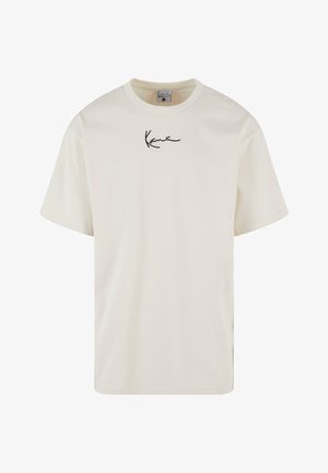 Krémové bavlněné tričko s krátkymi rukávmi. Obsahuje čierny podpisový textový logo na prednej strane. Okrúhly výstrih a voľný strih.