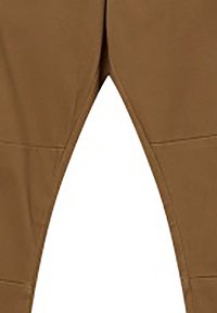 Pantalon marron avec des coutures visibles le long des coutures intérieures des jambes, photographié sur fond blanc.