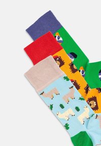 Calcetines de novedad en varios colores: púrpura, rojo, naranja, verde y azul con patrones de animales y cactus; textura acanalada en los bordes.