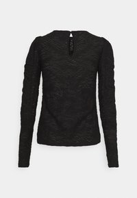 Haut noir à manches longues avec texture et motifs ondulés subtils, avec une petite ouverture en forme de goutte d'eau au dos, au niveau de l'encolure.