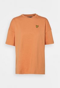 Camiseta de manga corta en algodón naranja, con un logotipo de ave bordado en negro y amarillo en el pecho. Cuello redondo y corte relajado.