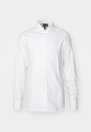 Witte lange mouw shirt met een subtiel reliëf logo patroon, knoopsluiting en een klassieke kraag. Zachte, gestructureerde stof, getailleerde pasvorm.