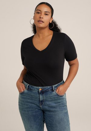 Black V-neck T-shirt with short sleeves, made of smooth fabric. Paired with high-waisted blue denim jeans, featuring a button and pockets.