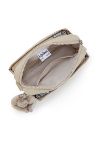 Beige rectangular pouch with a zip closure, interior pockets, and a fluffy keychain accent. Made from soft, durable fabric.