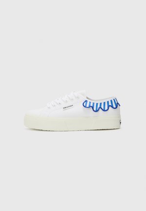 White canvas sneakers with a textured white sole, featuring a blue and white striped ruffled accent along the back and a small logo on the side.