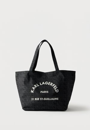 Sac cabas noir avec motif répétitif "KARL LAGERFELD" et texte blanc "KARL LAGERFELD PARIS 21 RUE ST-GUILLAUME" à l'avant.
