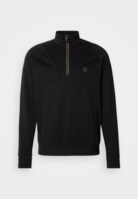 Felpa nera con zip e colletto alto, dettagli in oro sulla zip, accenti testurizzati sulle spalle e logo sul petto sinistro. Tessuto morbido.