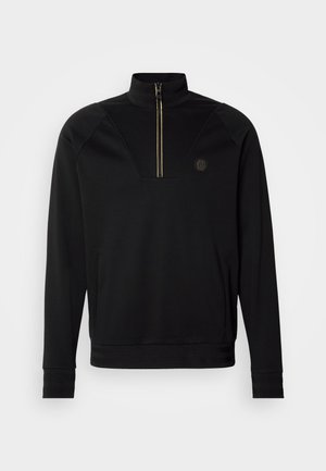 Black zip-up sweatshirt with high collar, gold zipper detail, textured accents on shoulders, and logo on the left chest. Soft fabric.