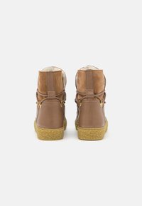 Brown leather ankle boots with tan suede accents, textured outsole, and padded lining. Features gold-tone hardware and flexible construction.
