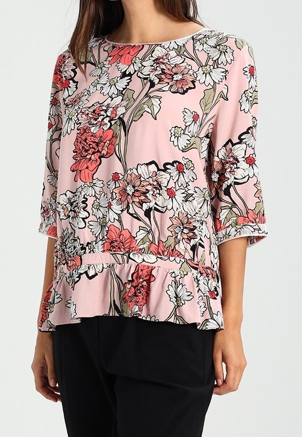 Floral blouse in pink, featuring short sleeves, a peplum hem, and black outlines. Design includes white and red flowers on a soft texture.