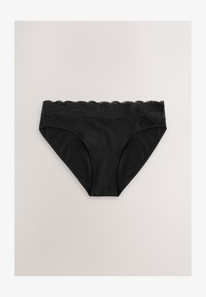 Culotte noire en tissu lisse avec une ceinture en dentelle festonnée. Présente une coupe bikini classique et un design sans coutures.