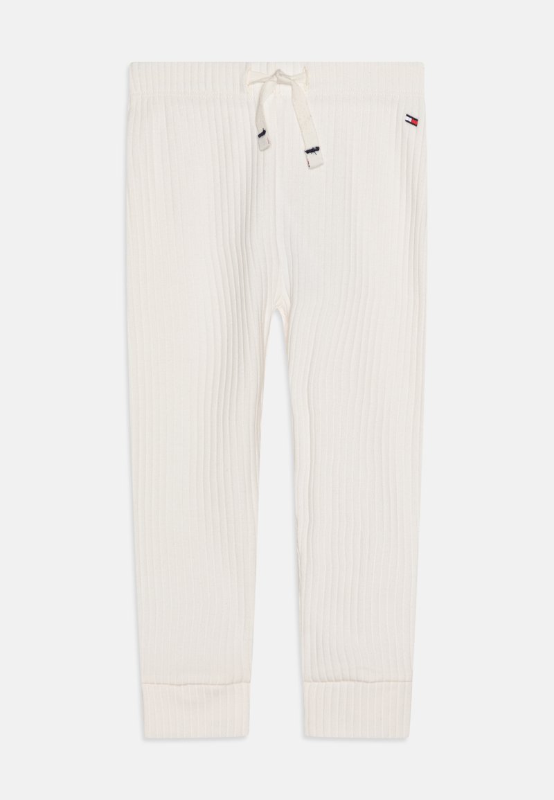 Jogger crema a coste con vita elastica, cordoncino e polsini a coste; presenta una piccola etichetta del logo vicino alla vita.
