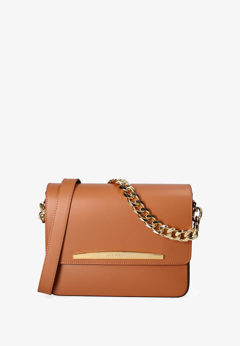 Sac en bandoulière en cuir tan avec une chaîne dorée, forme rectangulaire épurée et un subtil accent doré à l'avant.