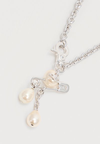 Silver chain necklace with a silver safety pin pendant holding three irregular white pearls, two dangling from small silver links.