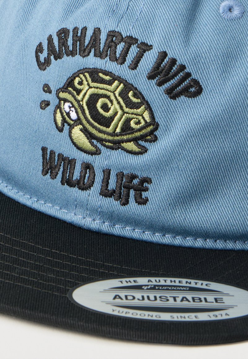 Blue and black adjustable cap with embroidered turtle and text "Carhartt WIP Wild Life" on front panel.