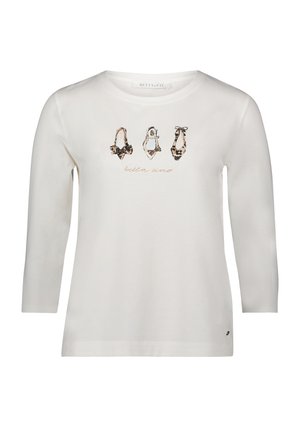 Biała koszulka z długim rękawem z grafiką trzech różnych butów w panterkę oraz napisem "bella italia" poniżej. Wykonana z miękkiego bawełnianego materiału.