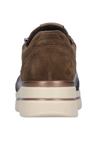 Brown suede sneaker with a textured design, metallic accents, and a thick cream midsole. Rear view highlights the shoe's shape and materials.