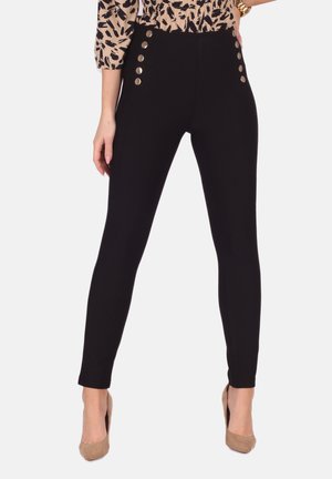 Schwarze hoch taillierte Leggings mit goldfarbenen Knopf-Akzenten an den Seiten. Hergestellt aus dehnbarem Material, das eng an den Beinen anliegt.