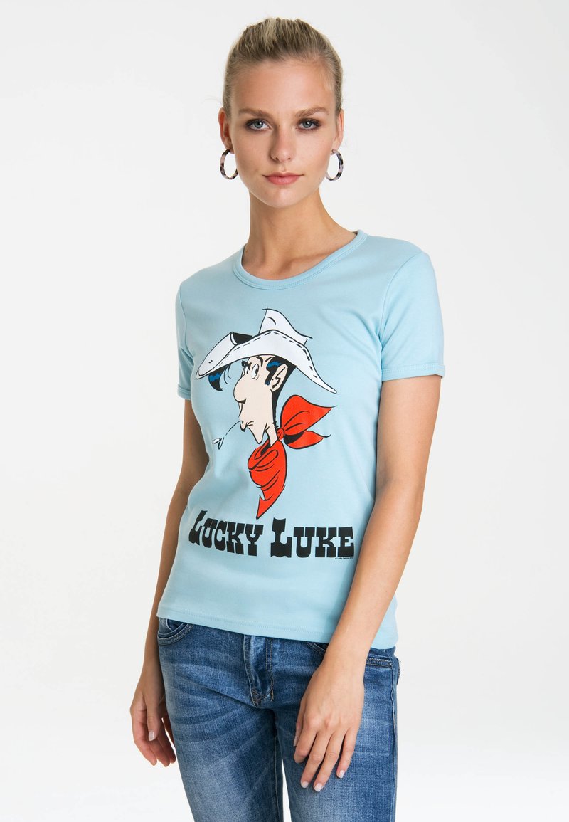 Light blue cotton t-shirt featuring a graphic of a character with a white cowboy hat and red bandana, labeled "LUCKY LUKE" in bold black text.