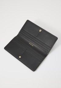 Black leather wallet, featuring multiple card slots, a textured finish, and a gold snap closure. Interior brand logo visible.