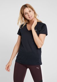 Kurzärmliges, navyblaues Sport-T-Shirt mit einem V-Ausschnitt und glattem, leichtem Material. Verfügt über ein kleines Logo auf der Brust.