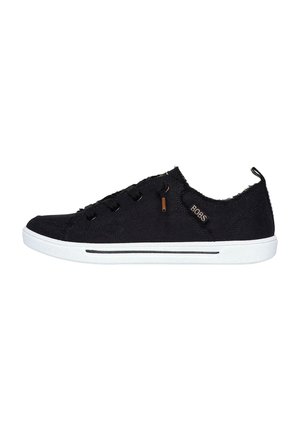 Black canvas sneaker with a low profile, white rubber sole, round toe, and textured fabric. Features minimal branding and black accents.