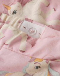 Tissu rose avec des illustrations de licornes, d'une texture douce. La fermeture comprend un bouton transparent et un détail de boucle pour un maintien sûr.