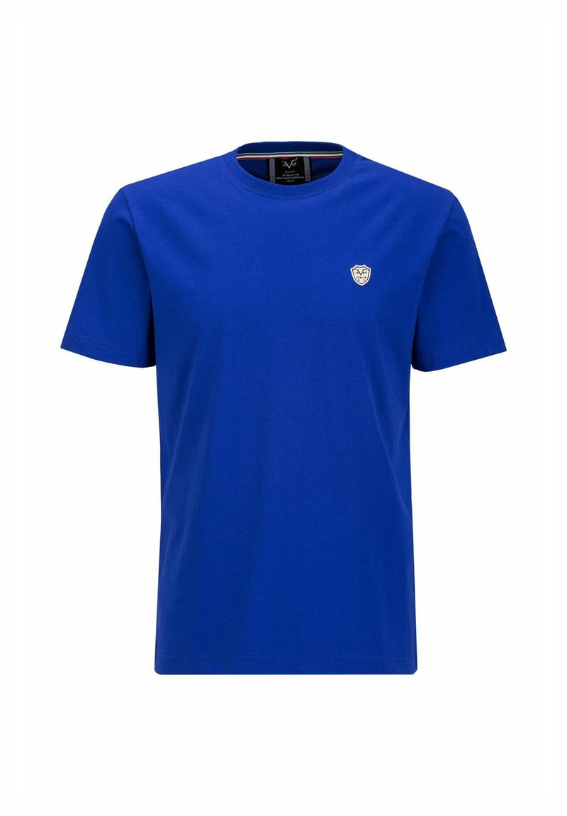 T-shirt en coton bleu avec un col ras du cou, des manches courtes et un petit écusson logo blanc sur la poitrine gauche. Texture lisse, coupe régulière.