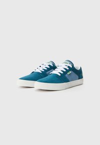 Teal suede sneakers with white laces and rubber soles. Features a padded collar and contrasting blue accents on the sides.