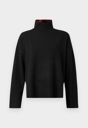 Pull à col roulé noir, fabriqué en tissu tricot doux. Doté d'un col et de poignets côtelés, avec une coupe décontractée et une longueur courte.