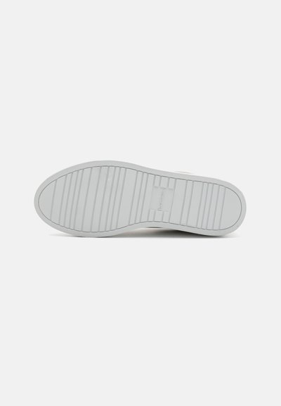 White rubber sneaker sole with a textured surface, featuring horizontal and vertical ridges for grip. Clean, minimalist design.
