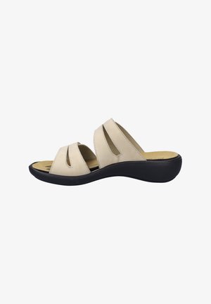 Beige sandal with multiple cut-out straps, soft leather upper, cushioned insole, and a curved black rubber sole for flexibility and comfort.