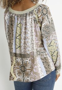 Haut à manches longues avec encolure froncée ; motif patchwork multicolore en nuances de beige, vert et violet ; tissu doux, coupe décontractée.