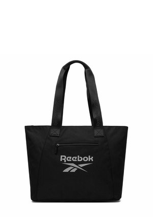 Schwarze Reebok-Handtasche mit doppelten Griffen, vordere Reißverschlusstasche und reflektierendem Logo, das unterhalb der Tasche zentriert ist.