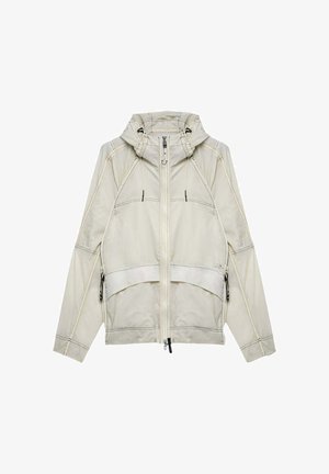 Giacca con cappuccio beige chiaro con zip frontale, tasche laterali con zip e dettagli di cuciture visibili sulle maniche e sui pannelli anteriori.