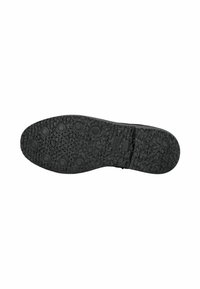 Suela de zapato negra con patrón texturizado, grips circulares en la mitad frontal y pequeñas perforaciones en el área central.