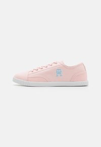 Pink canvas sneakers with white rubber soles, featuring a textured side panel and light blue logo on the outer side. Classic lace-up design.